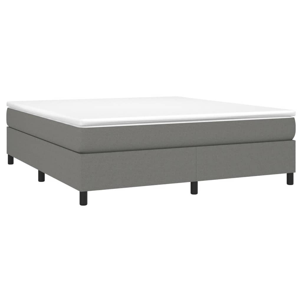 Grey upholstered divan bed base with a white mattress