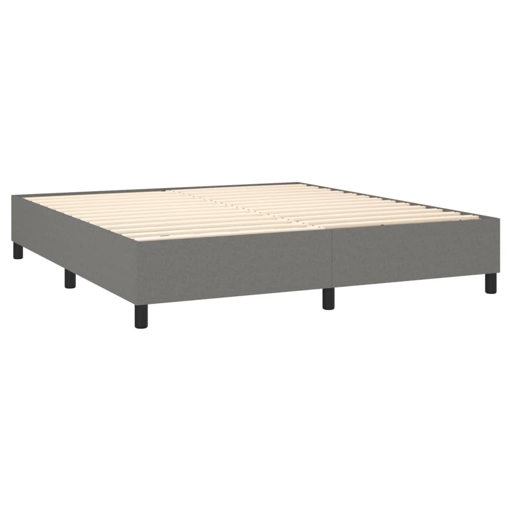 Gray upholstered divan bed frame with white mattress