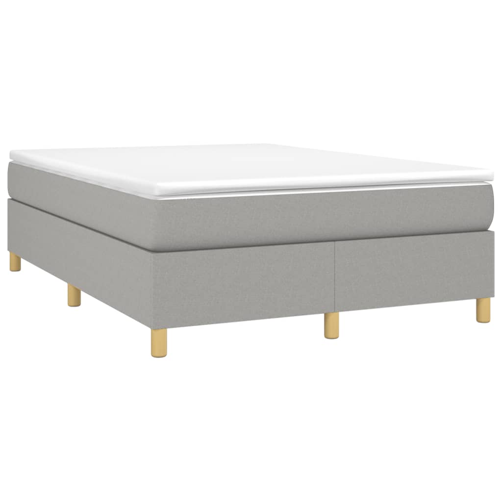 Grey upholstered divan bed with white mattress and golden legs