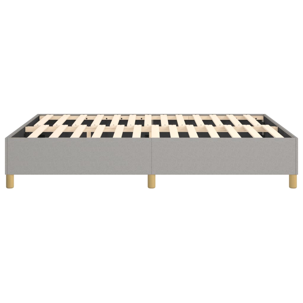 Grey fabric upholstered bed base with wooden slats and legs