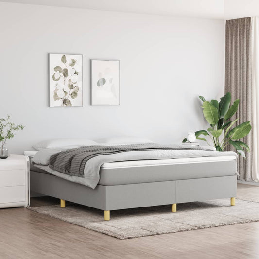 Grey upholstered divan bed with wooden legs