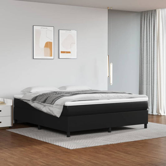 Black upholstered bed frame with white mattress and grey throw