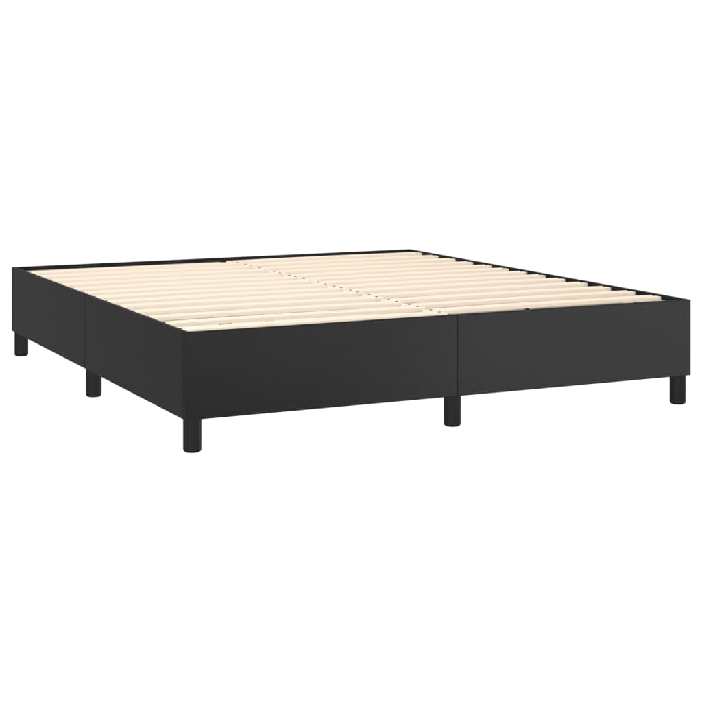 Black upholstered bed frame with white mattress