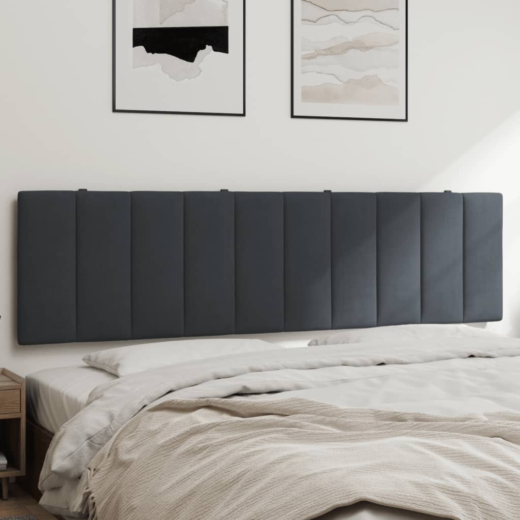 Dark grey upholstered headboard with vertical stitching mounted above a bed