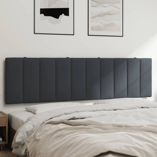 Dark grey upholstered headboard with vertical stitching mounted above a bed