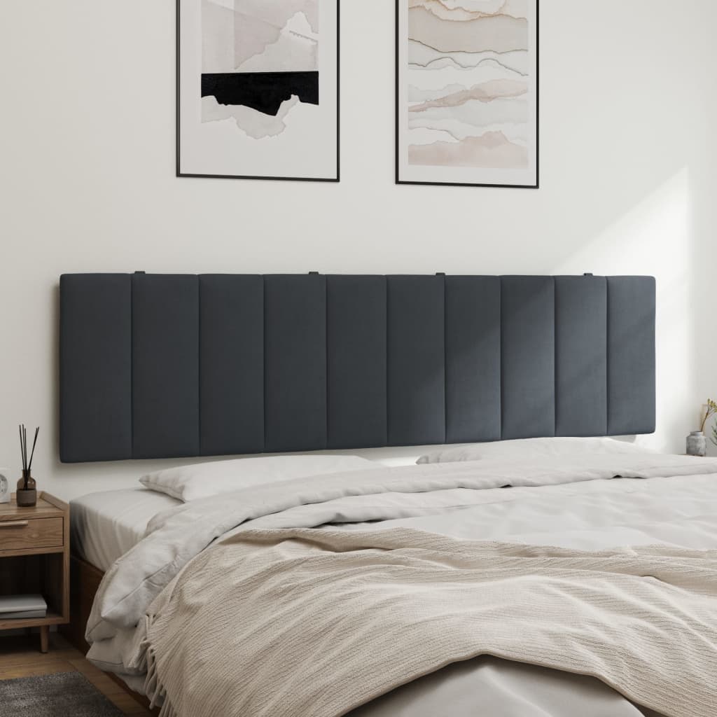 Dark gray upholstered vertical channel headboard on a bed with white linens