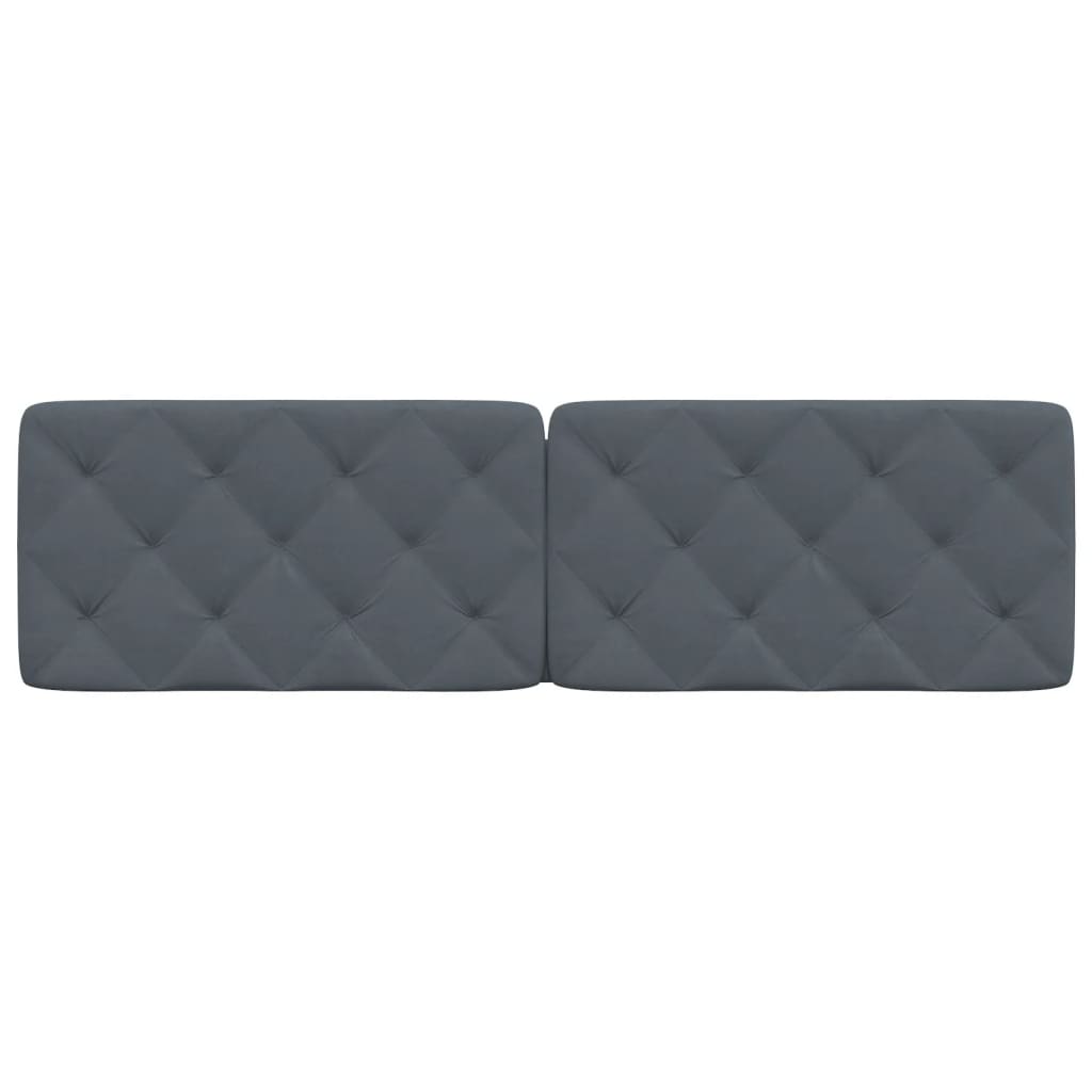 Two upholstered dark grey diamond tufted headboards mounted above a bed