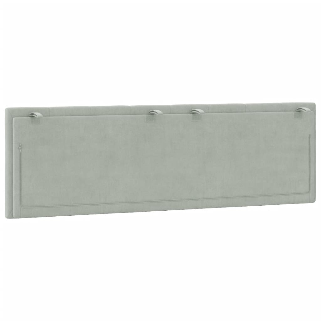 Light grey upholstered headboard with vertical channel tufting and a curved metal bracket