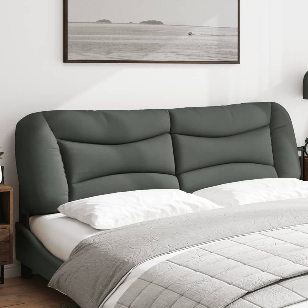 Dark grey upholstered headboard with quilted detail mounted above a bed