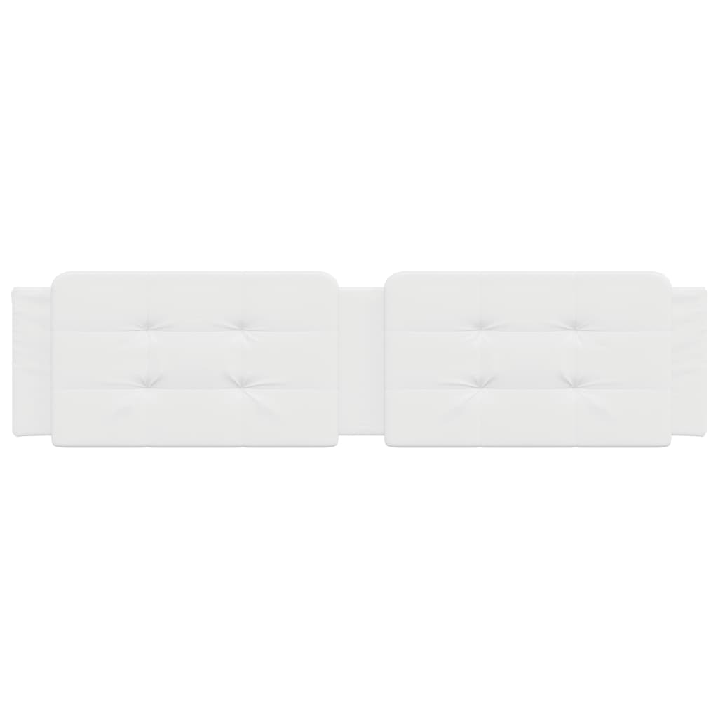 Tufted white faux leather headboard panels mounted on a wall above a bed
