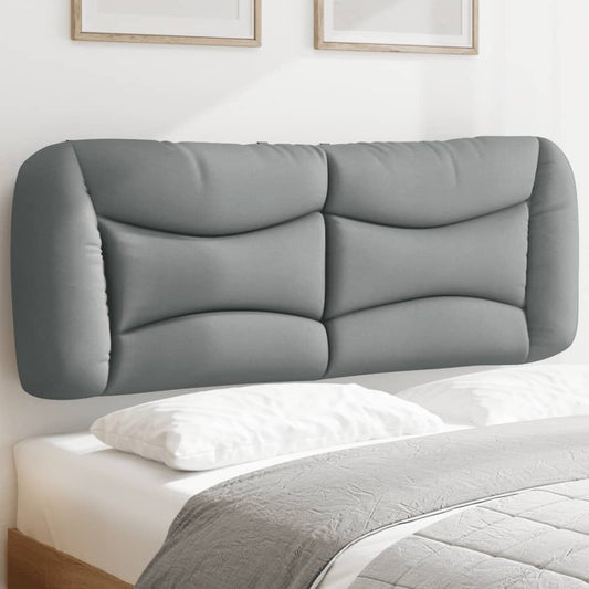 Grey upholstered headboard with curved panels mounted above a bed