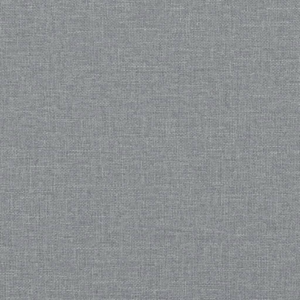 Closeup of a plush grey fabric accent chair with curved armrest detail