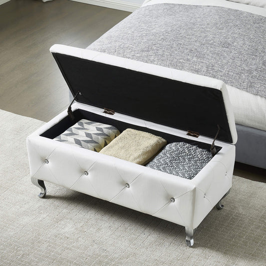 White tufted storage bench with crystal buttons and silver legs storing blankets