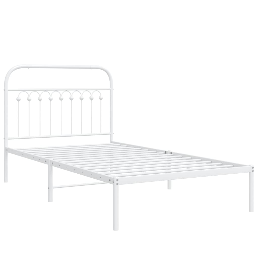 White metal bed frame with decorative headboard and pale blue bedding