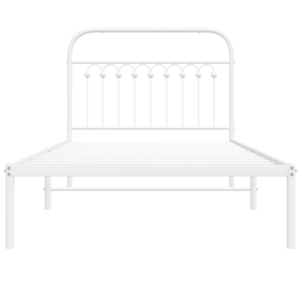 White metal twin bed frame with a decorative headboard