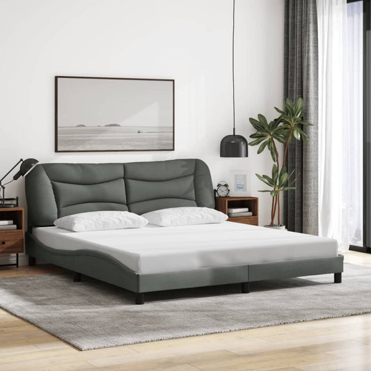 Grey faux leather platform bed frame with curved headboard and white mattress