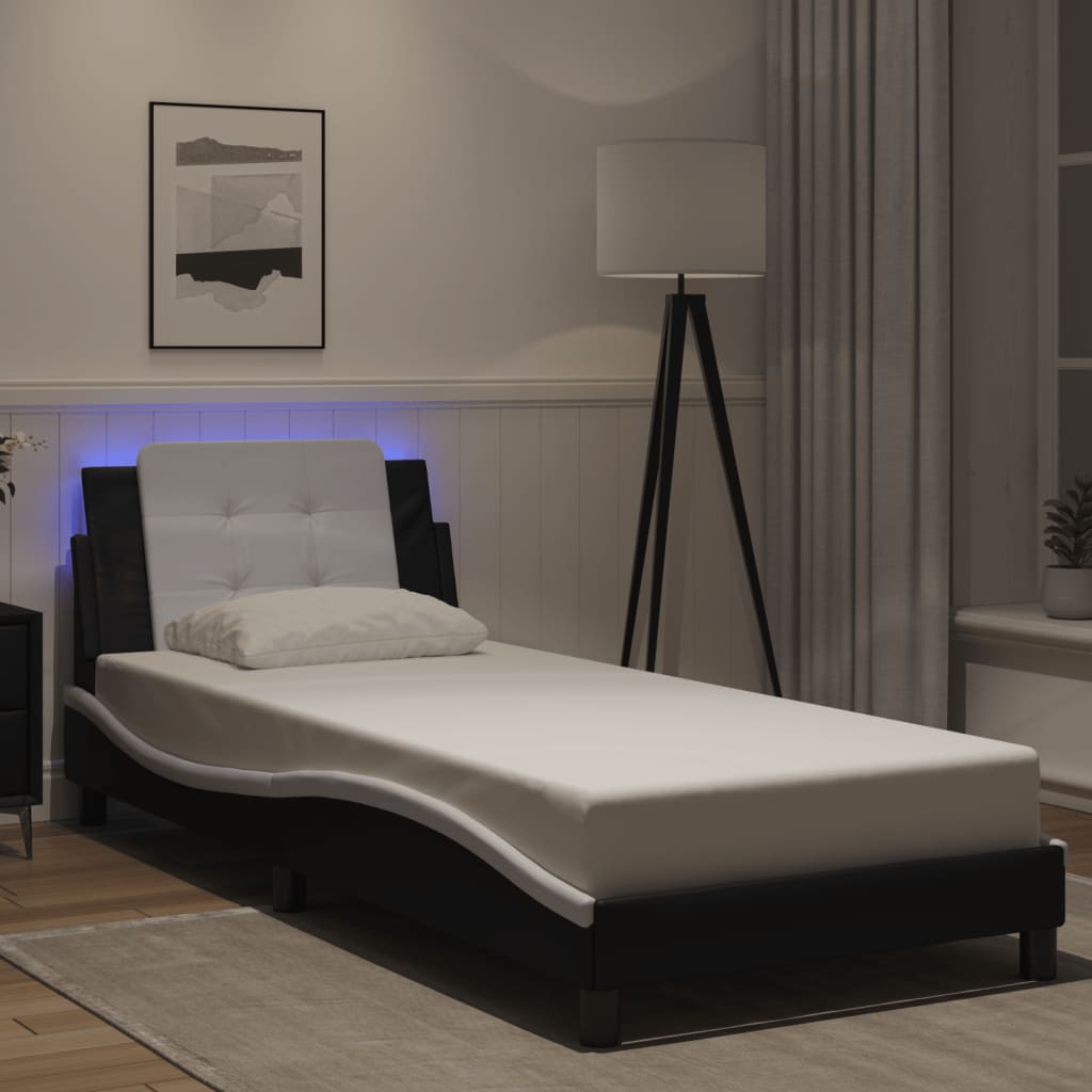 Black faux leather twin bed frame with white tufted headboard and blue LED lights