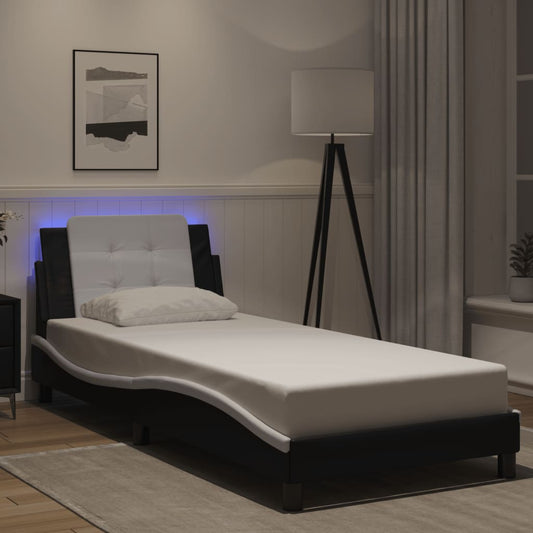 Black faux leather twin bed frame with white tufted headboard and blue LED lights