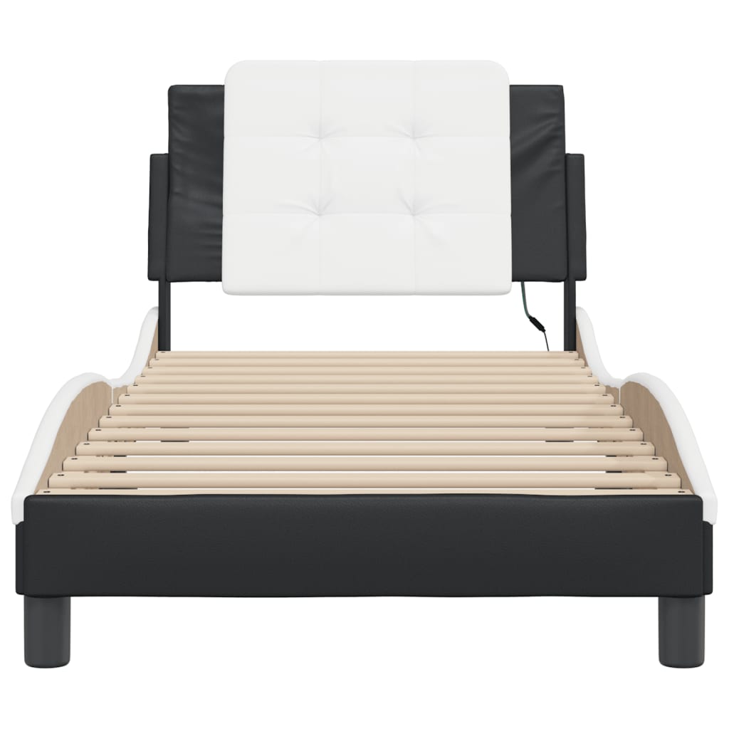 Black leatherette chaise lounge with white tufted headrest and mattress