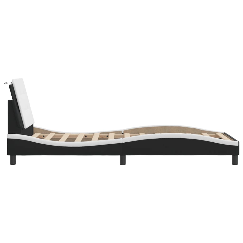 Black and white upholstered bed frame with tufted headboard and slatted base