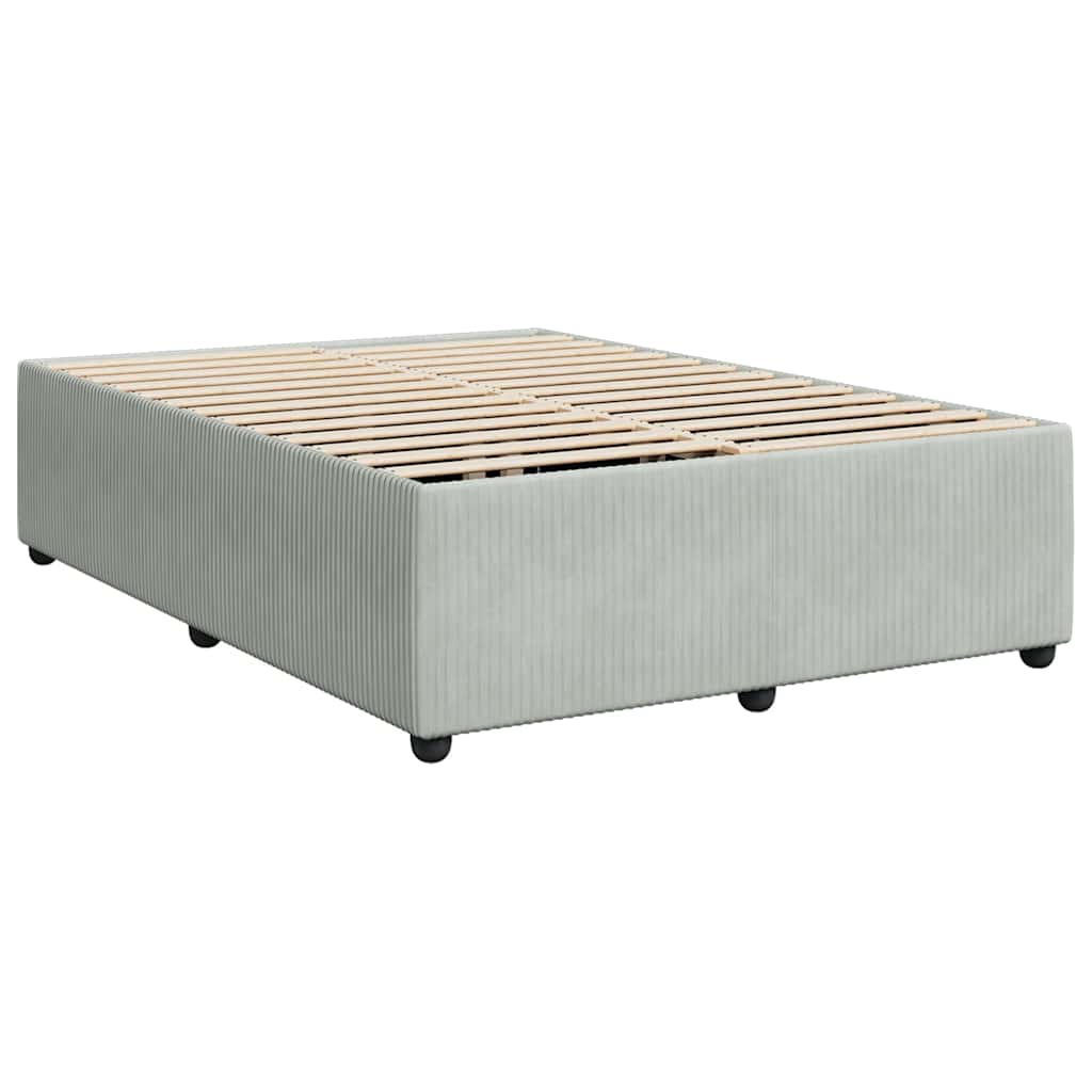 Light grey divan bed base with white bedding and pillows