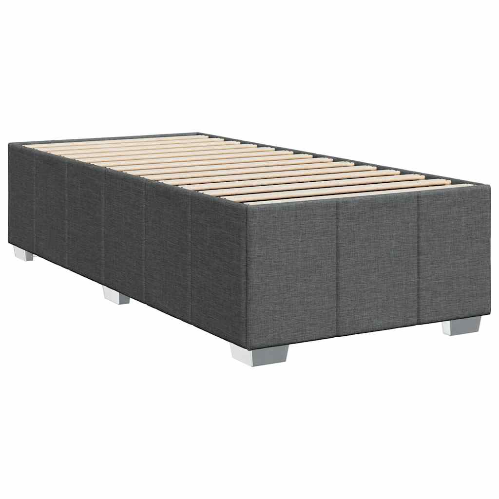 Dark grey fabric divan bed base with white mattress and bedding