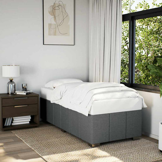 Grey upholstered divan bed with white bedding