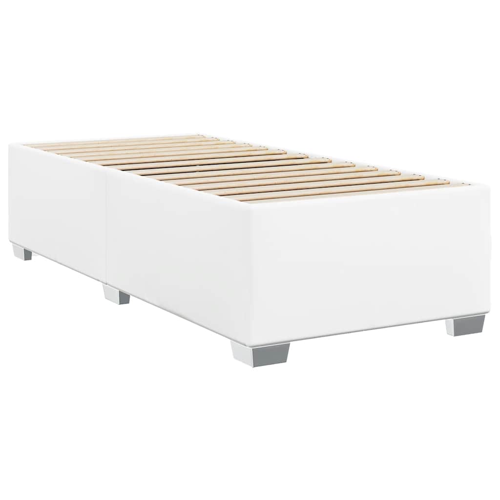 A white divan bed with a textured mattress and white duvet featuring silver metal legs