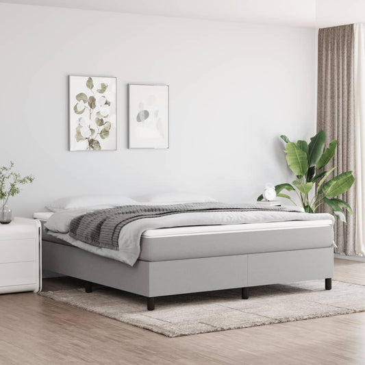 Modern grey upholstered divan bed with mattress and duvet