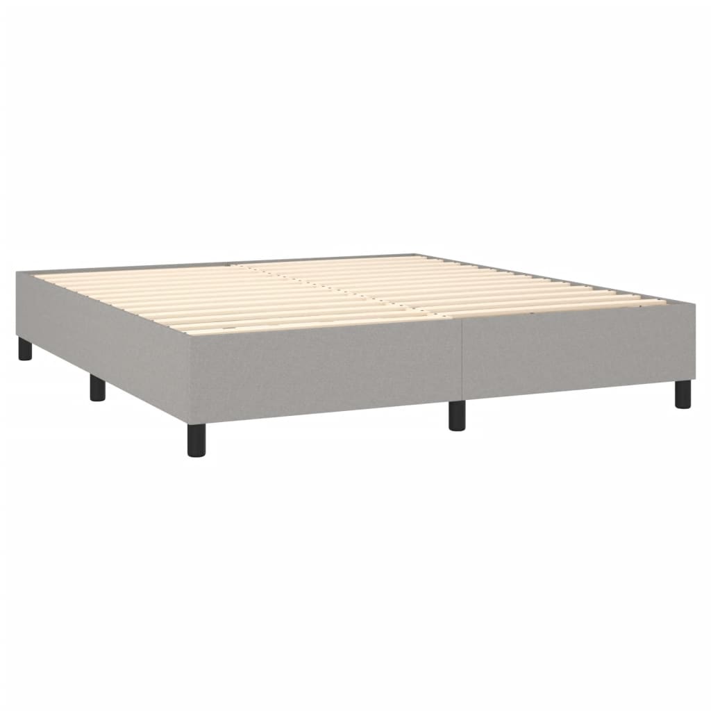 Gray fabric upholstered bed frame with white mattress