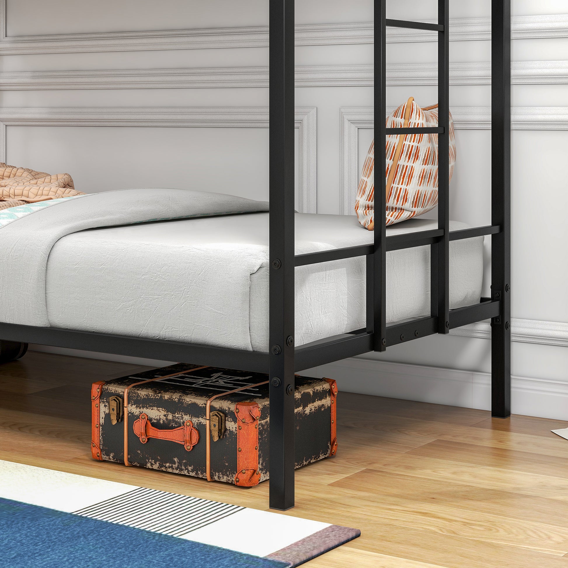 Black metal bunk bed frame with white mattress and patterned pillow
