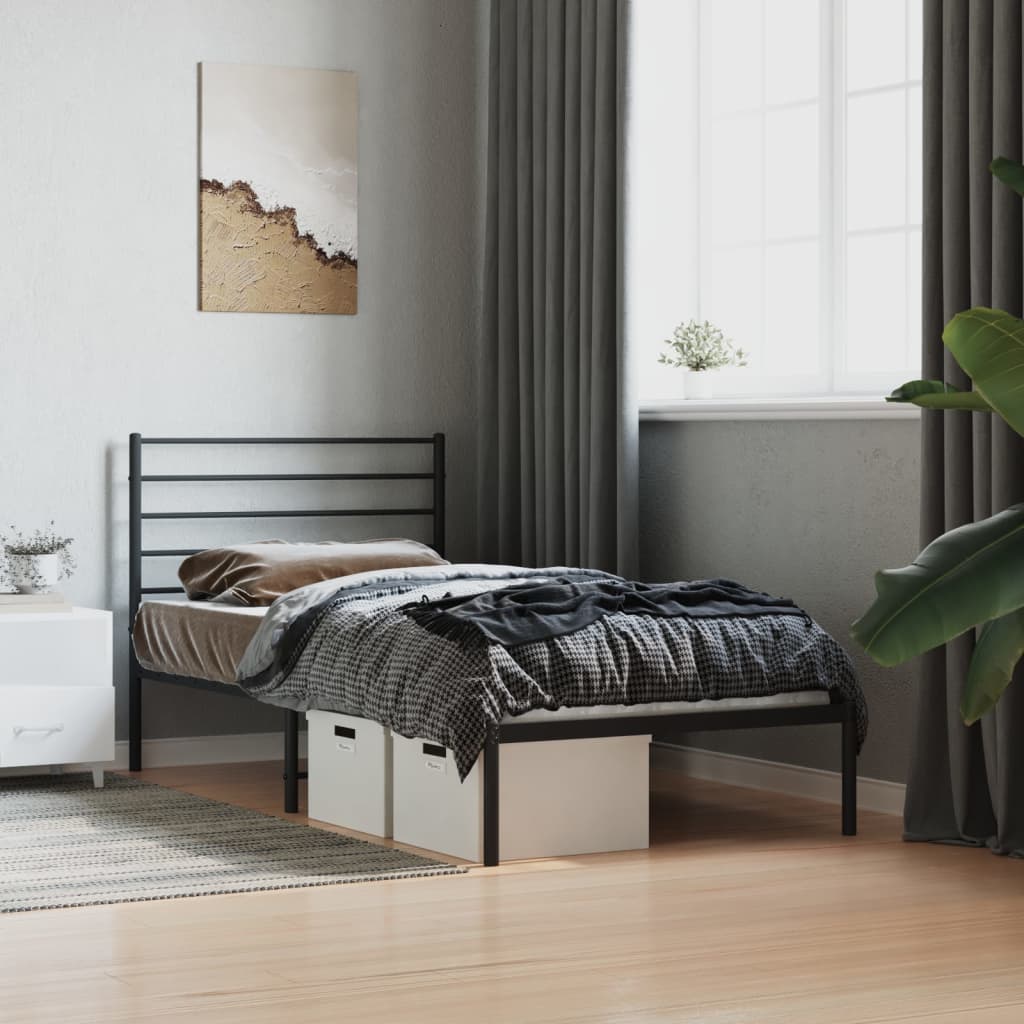 Black metal twin bed frame with horizontal slats and grey bedding