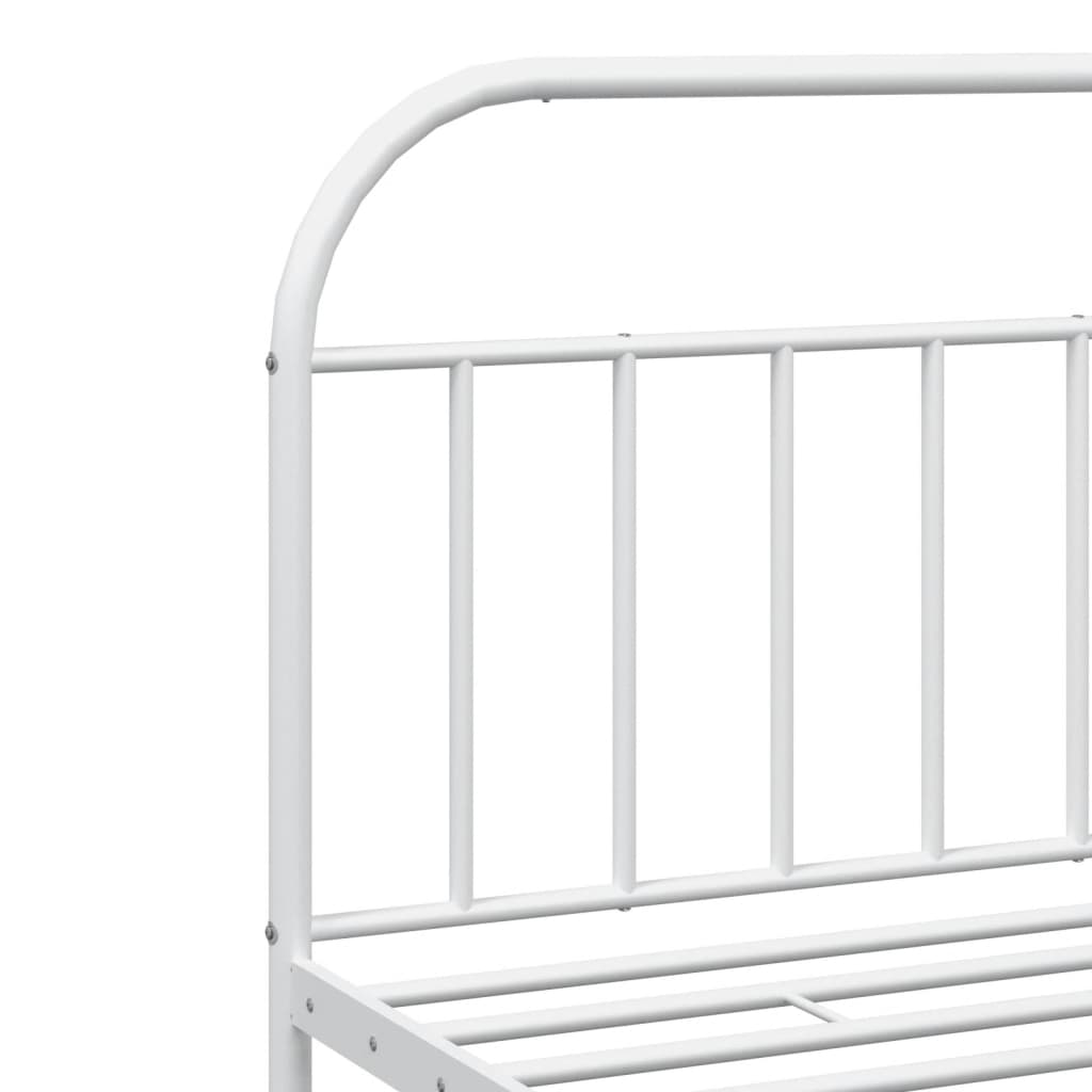 White metal twin bed frame with ornate scrollwork and slatted base