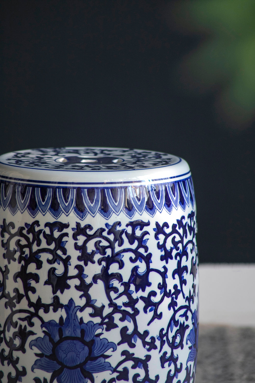 Blue and white ceramic stool with floral pattern