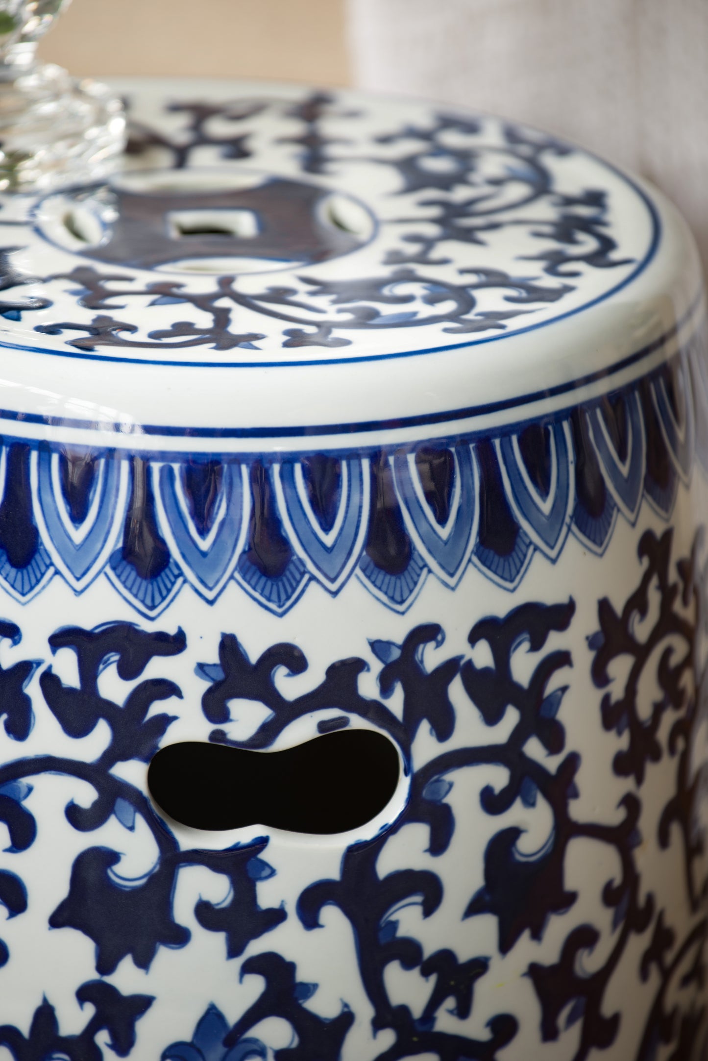 White ceramic garden stool with blue floral pattern and cutouts