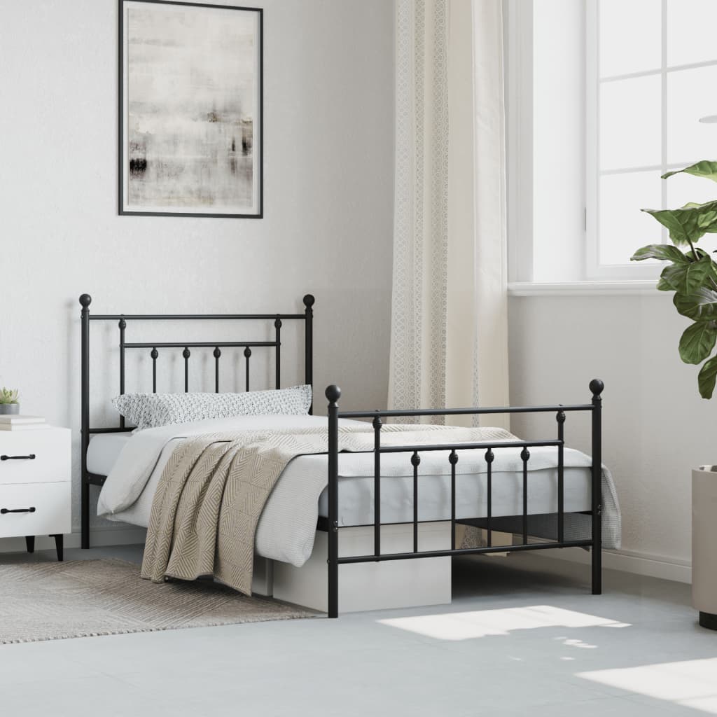 Black metal bed frame with ornate headboard and footboard