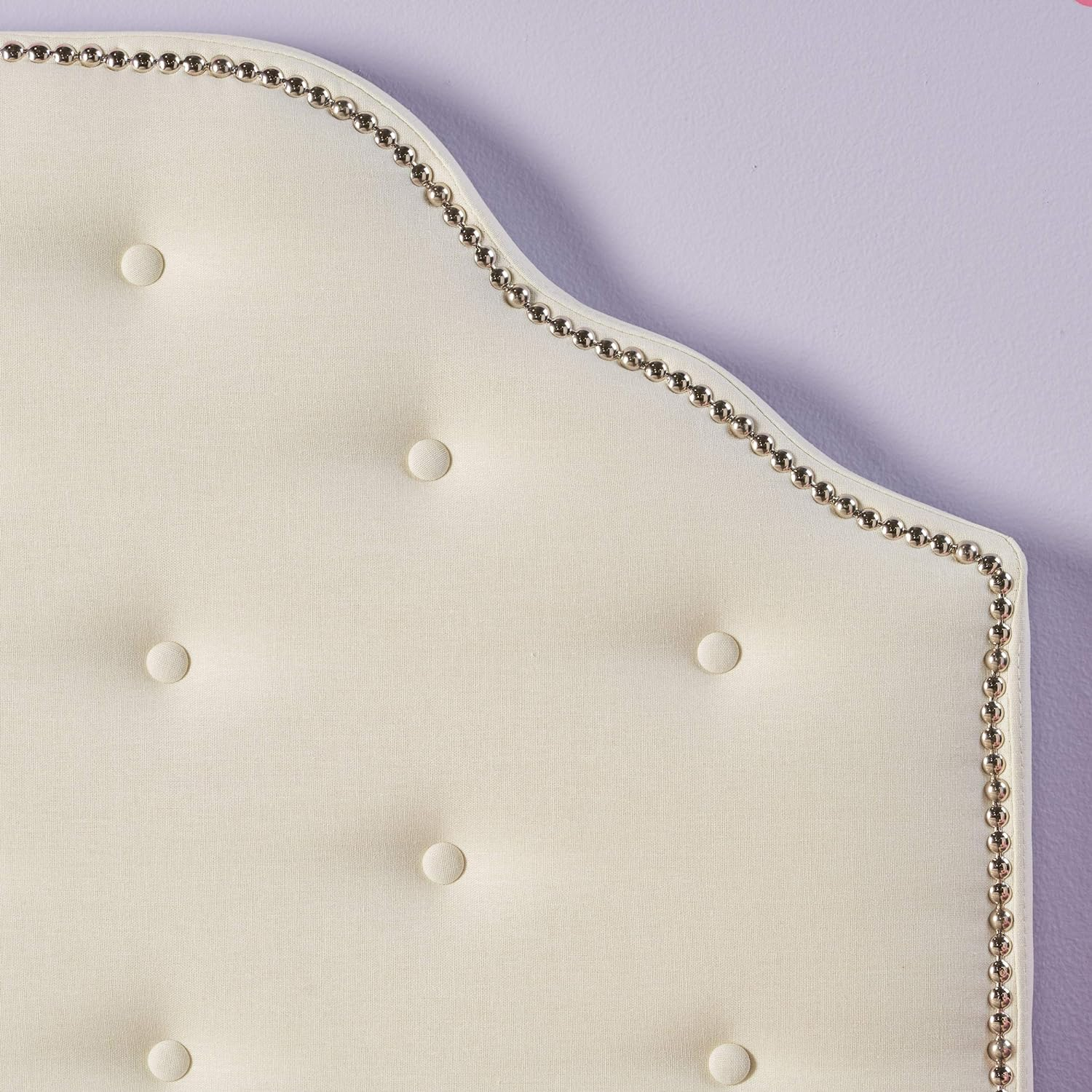 Cream fabric tufted headboard with silver nailhead trim