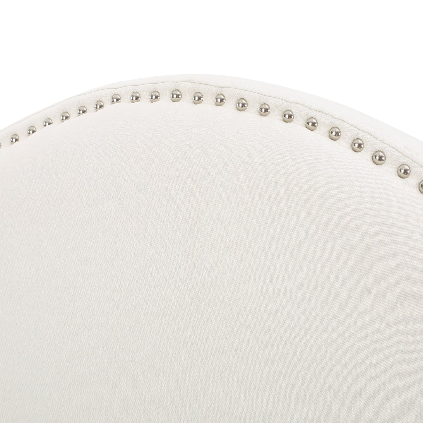 Upholstered wingback headboard detail in cream linen with silver nailhead trim