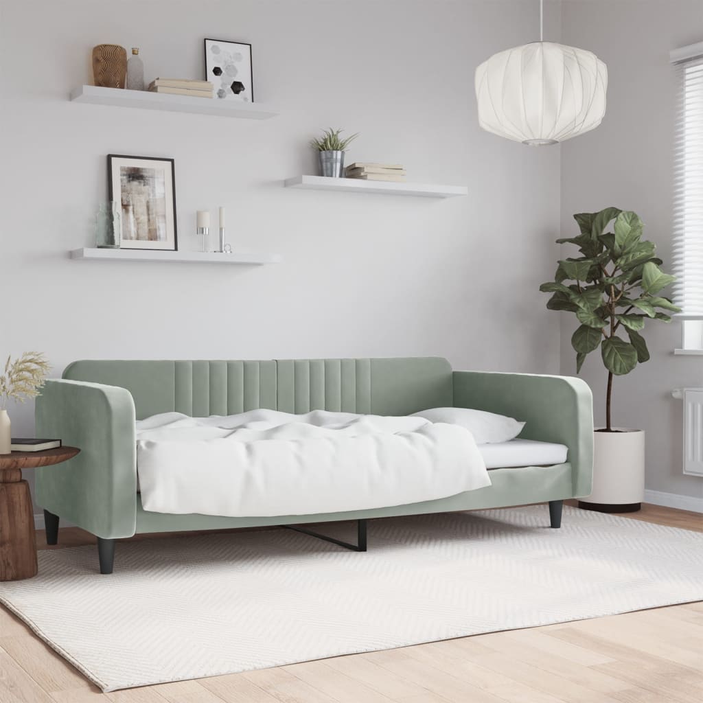 Sage green velvet sofa bed with white bedding ideal for small living spaces