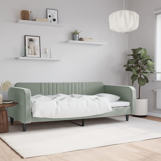 Sage green velvet sofa bed with white bedding ideal for small living spaces