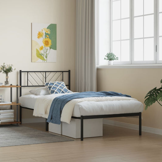 Black metal twin bed frame with patterned bedding and mountain art above