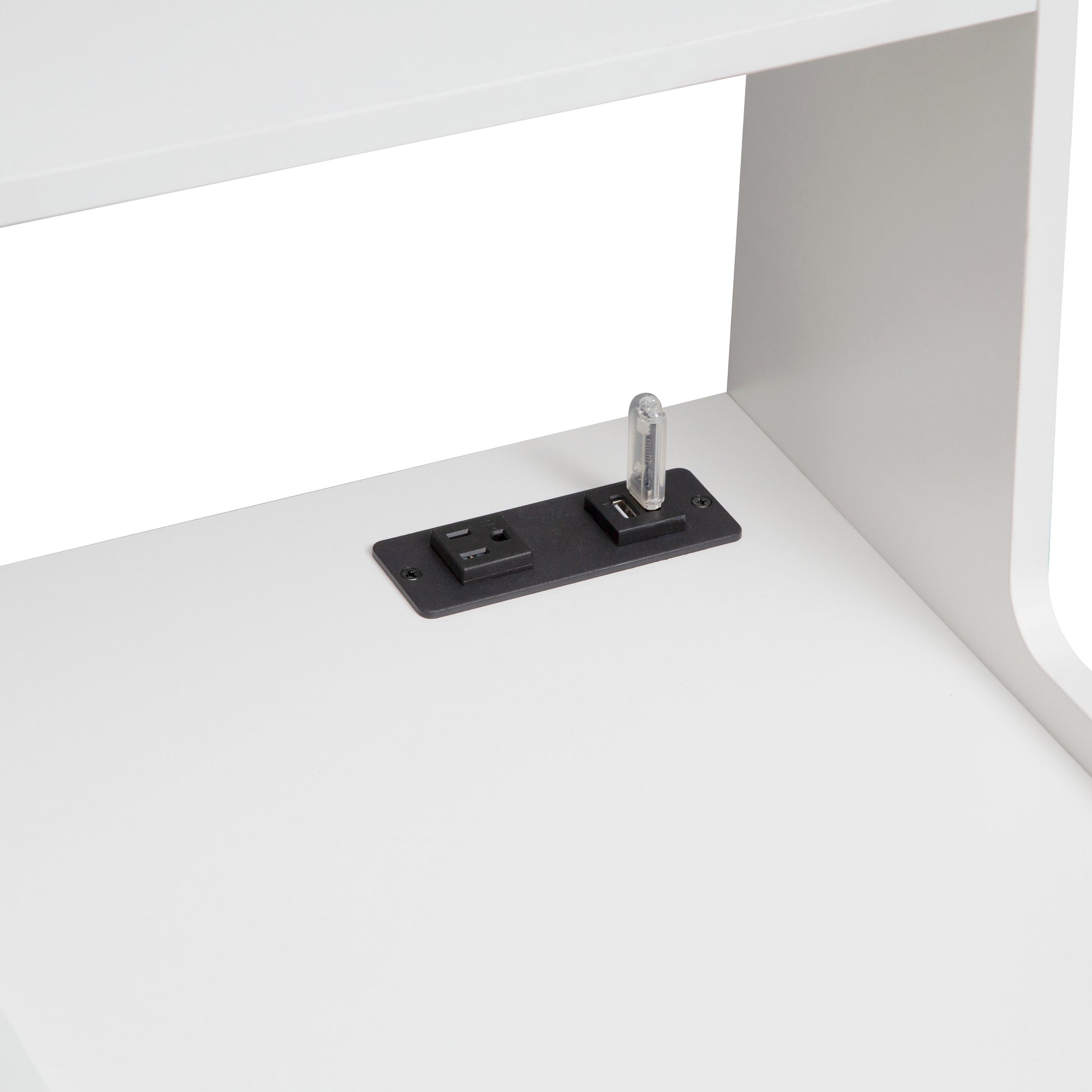 Integrated power strip with USB ports on a white desk surface