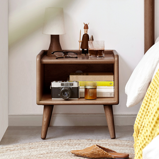 Midcentury modern walnut nightstand with books and vintage camera