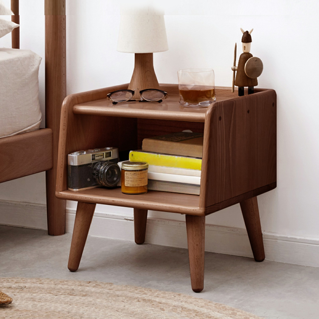 Wooden bedside table with a vintage camera and books