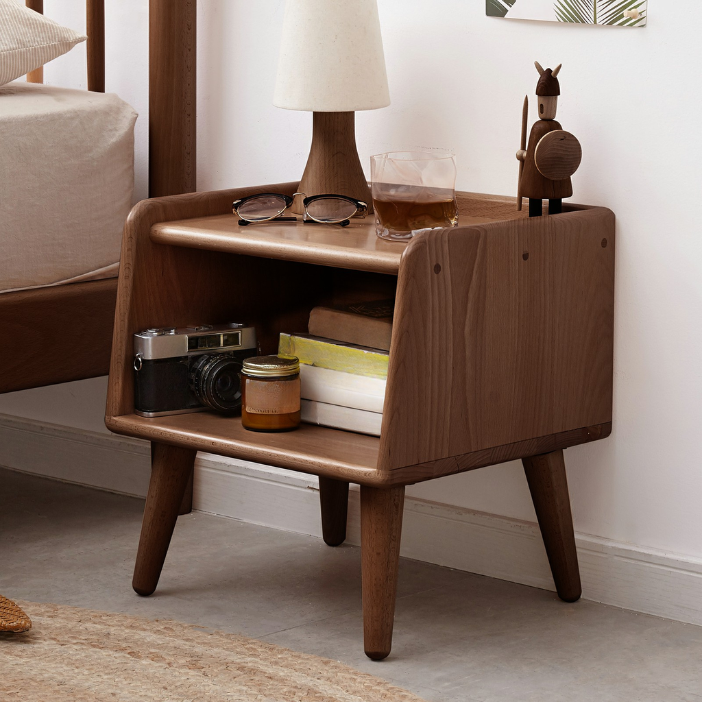 Midcentury modern walnut nightstand with vintage camera and amber candle