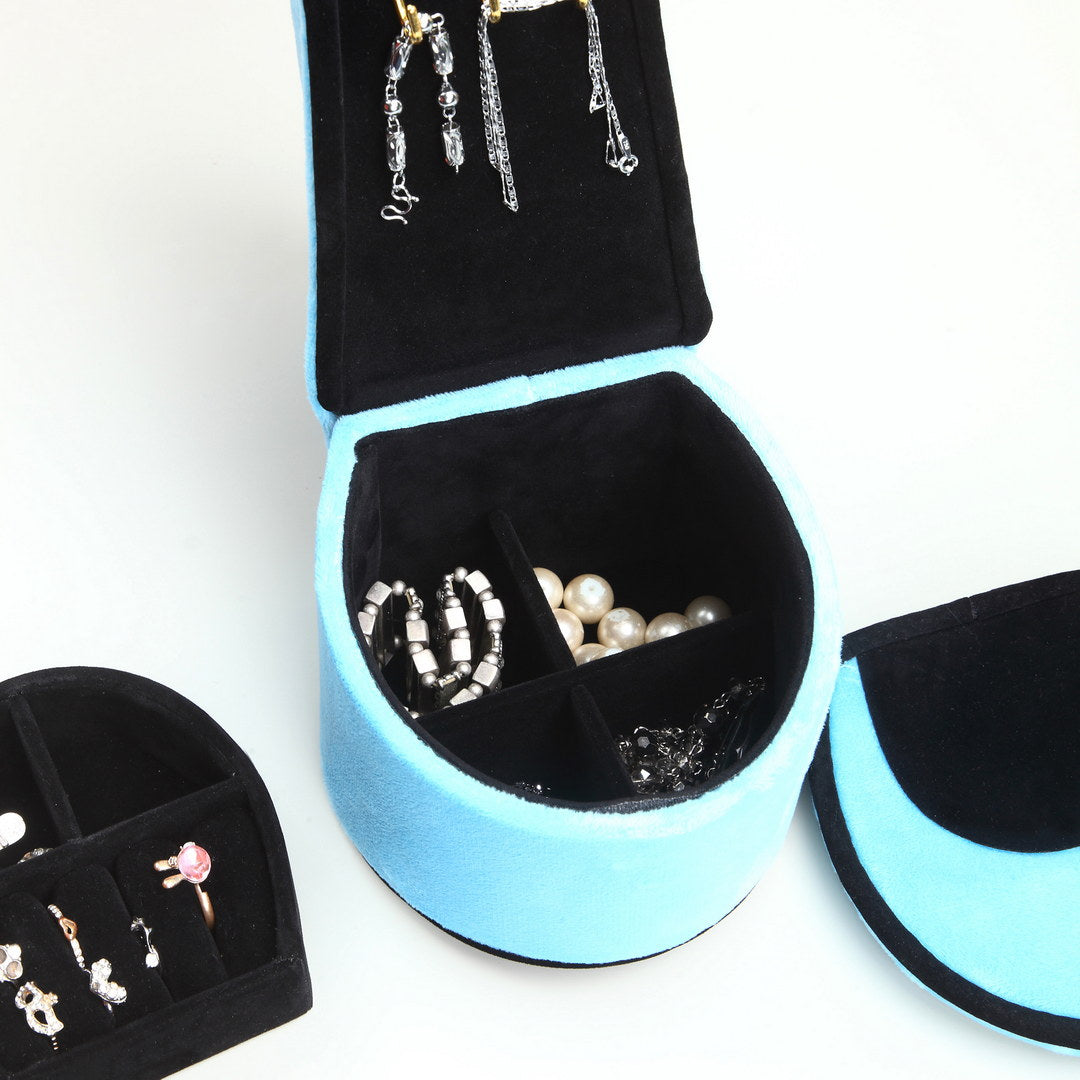 Blue velvet jewelry box with silver and pearl necklaces