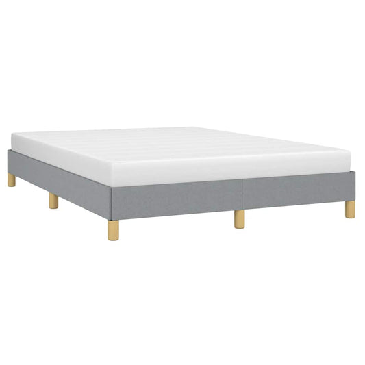 Grey upholstered twin bed frame with wooden legs and white bedding