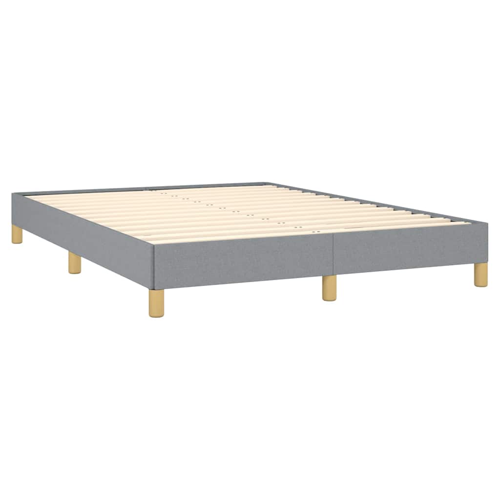 Gray fabric bed frame with four wooden legs and a white mattress