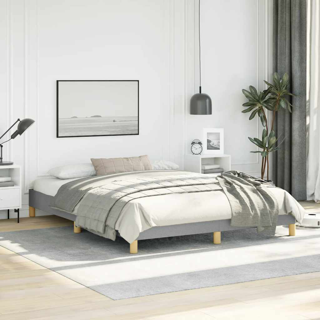 Grey upholstered twin bed frame with wooden slats and gold legs