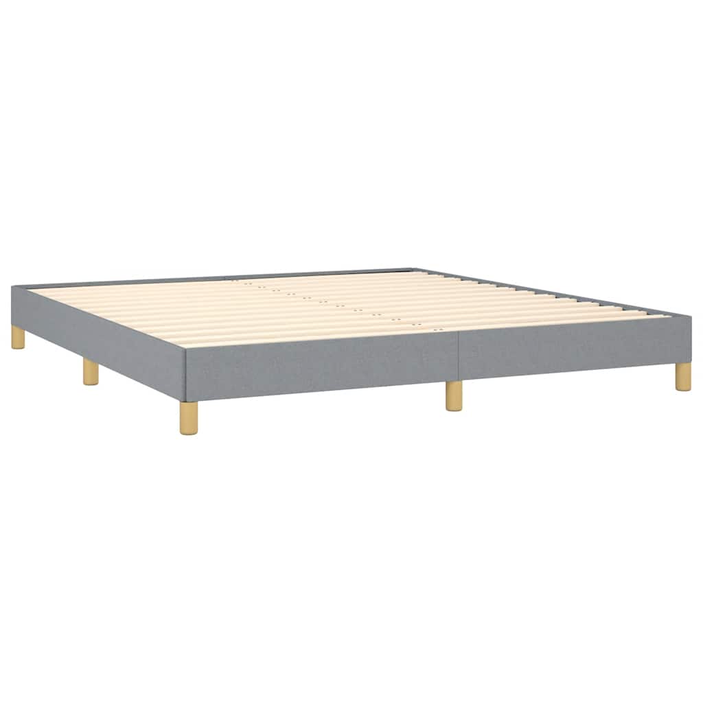 Gray upholstered bed frame with golden legs and white mattress